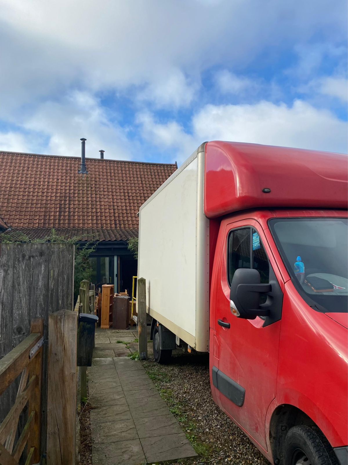 Our red van parked up at a clearance job