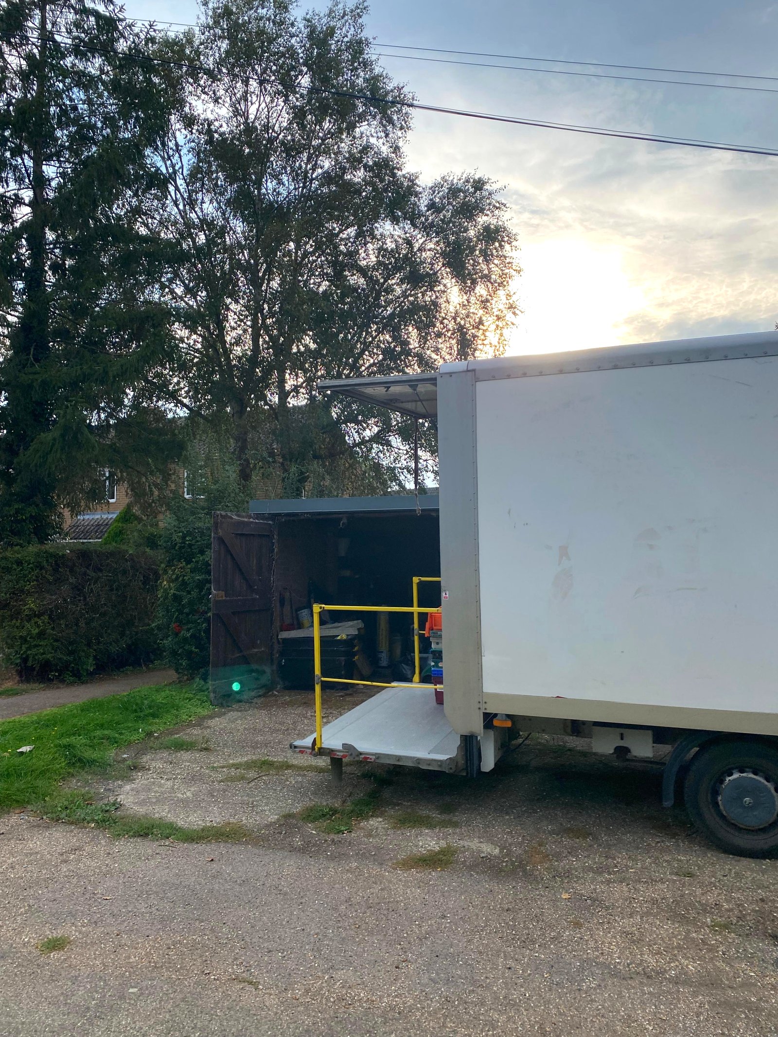 Our van with the tail lift down outside a garage during a clearance job